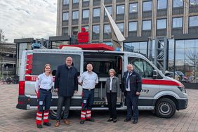 Das Einsatzteam der Malteser zusammen mit den Vertretern der Sparkasse vor dem Einsatzleitwagen. 