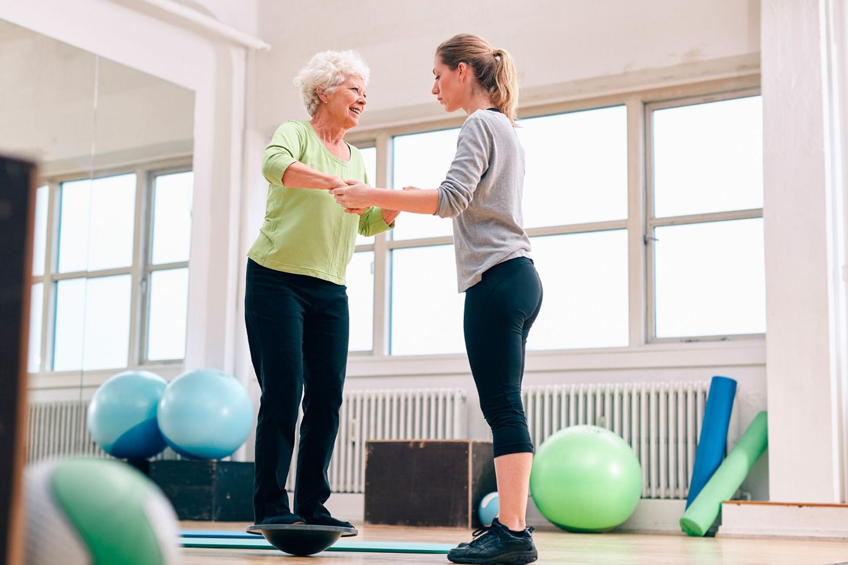 Patientin und ältere Damen bei einer Mobilisationsübung