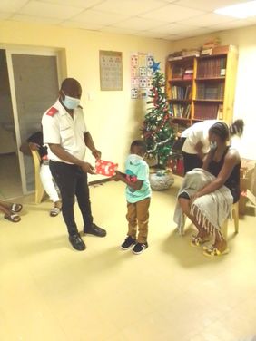 A child receives a wrapped Christmas gift.