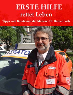 Dr- Löb vor einem Notartztwagen