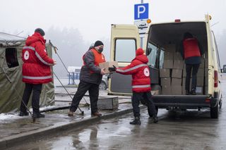 Helfende beladen einen Hilfsgütertransport