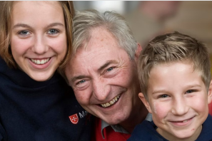 Eine Frau, ein Mann und ein Jungen blicken in die Kamera