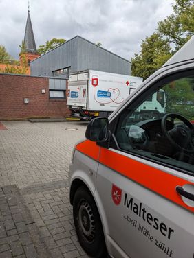 KTW der Malteser Aurich und LKW des Blutspendedienstes im Hintergrund