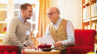 Ein älterer Mann und ein jüngerer sprechen über die Patientenverfügung.