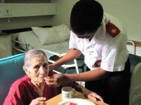 A nurse cares for an older patient.