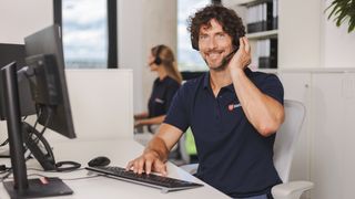 Malteser Mitarbeiter in der Hausnotrufzentrale nimmt einen Anruf an.