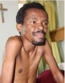 Sabatha sitting on a bed at the Care Centre.