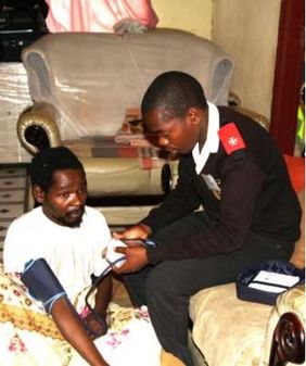 Care worker checks Siphamandla’s blood pressure; newsletter no. 35, 2016