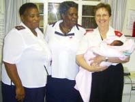 Three Children’s Home staff members with an infant.