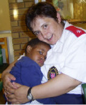 Care worker holding a child.
