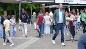 Herr Harnischmacher läutet symbolisch mit der alten Schulglocke den Beginn der Schulzeit am LFG ein