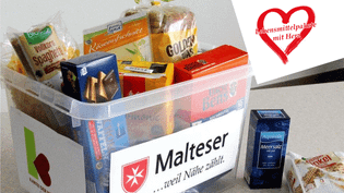 Transparente Kunststoffbox, gefüllt mit verpackten Lebensmitteln, darauf ein Malteser Aufkleber