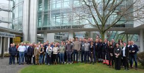 Die Teilnehmenden der Führungskräftetagung haben sich für ein Gruppenfoto vor der TÜV Rheinland Akademie zusammen gestellt.