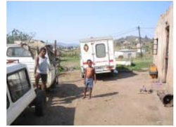 Ambulance and people in a settlement; archive photograph from newsletter no. 25 (2005).