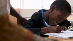 Mvelo working on his school assignments