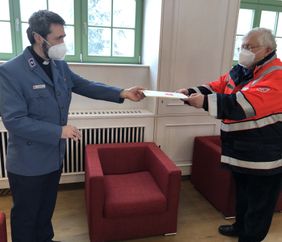 Malteser Ehrenamtlicher erhält feierlich eine Urkunde zur Berufung.