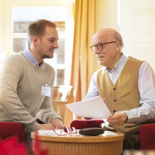 Malteser Mitarbeiter berät einen Senior