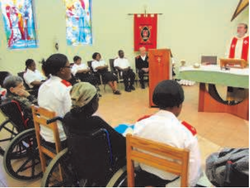 People seated at a service in the Care Centre.