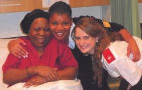 Iona Hughan with two women at the hospice