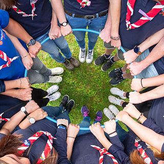 Malteser Jugendliche halten einen Reifen und stehen im Kreis