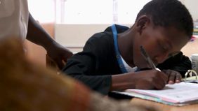 Mvelo working on his school assignments