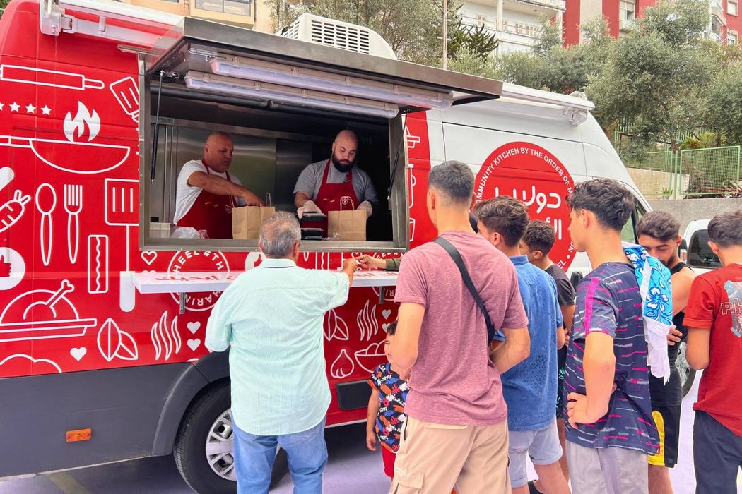 A mobile kitchen provides people with food.