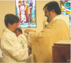 Father Gerhard baptising Sibusiso, held by Clare Kalkwarf.