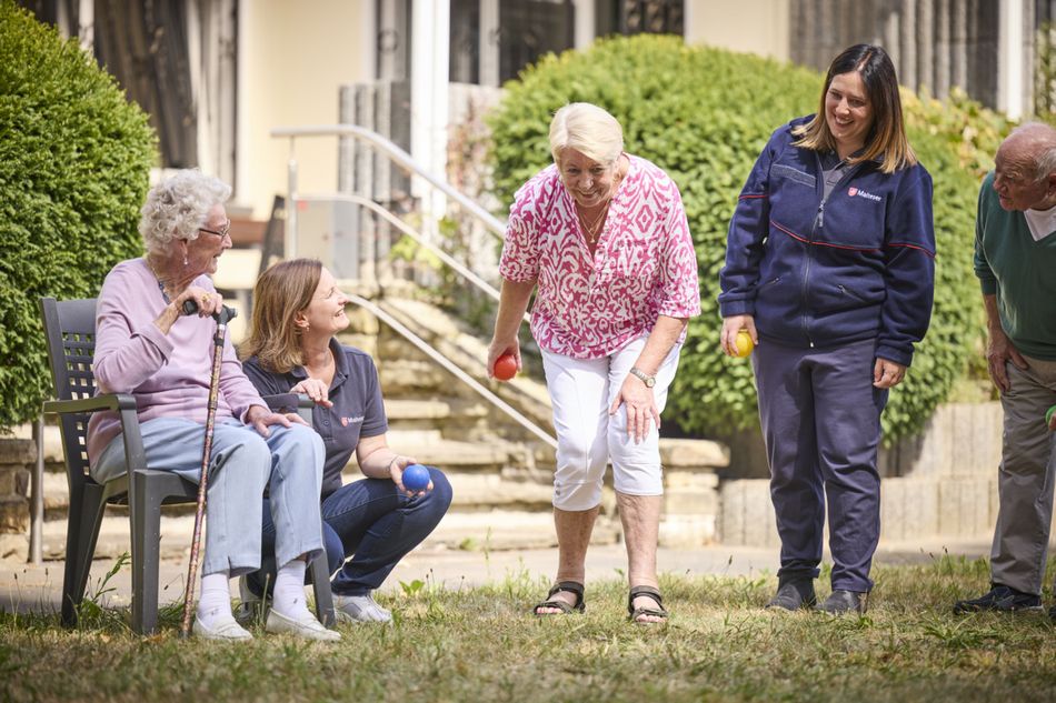 Eine Gruppe Menschen spielt im Freien Boccia