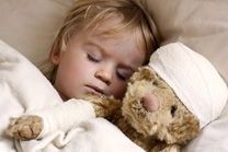 boy and teddybear in bed