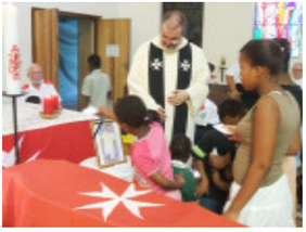 Children and adults at a memorial service.