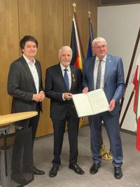 Hennefs Bürgermeister Mario Dahm (links) und Landrat Sebastian Schuster (rechts) freuen sich mit Helmut Klein über dessen Erhalt des Bundesverdienstordens für mehr als 60 Jahre ehrenamtlichen Engagements.