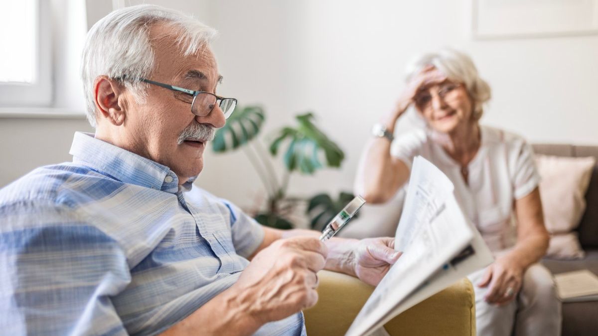 Zeitung lesen mit Lupe