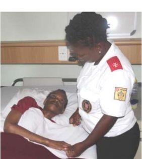 Nurse holds Nonhlanhla’s hand at the hospice; newsletter no. 38, 2019