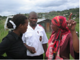 Three people during a HAART programme home visit; archive photograph from newsletter no. 26.
