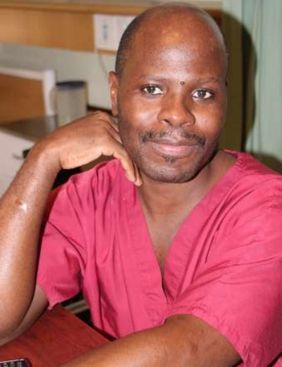 Joseph smiles in a red shirt; original photograph from newsletter no. 35 (2016), page 8.
