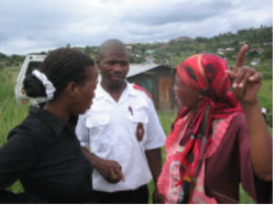 Three people during a HAART programme home visit; archive photograph from newsletter no. 26.