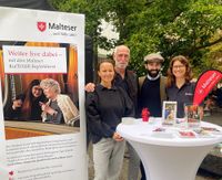 Vier Malteser am Stand des Kulturbegleitdienstes