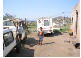 Ambulance and people in a settlement; archive photograph from newsletter no. 25 (2005).