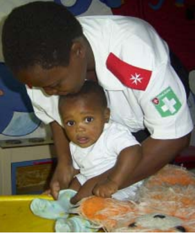 A care worker helping Sibusiso play.