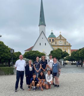 Bei der Hinfahrt machte die Gruppe mit Diözesanjugendseelsorger Johannes B. Trum (l.) und Diözesanjugendsprecherin Julia Eichberger (stehend 3.v.l.) einen ausgedehnten Halt in Altötting, hier auf dem Kapellplatz.