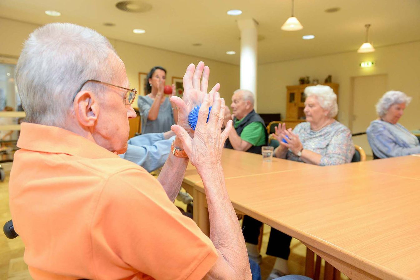 Bewohner nehmen bei der Handgymnastik zusammen teil