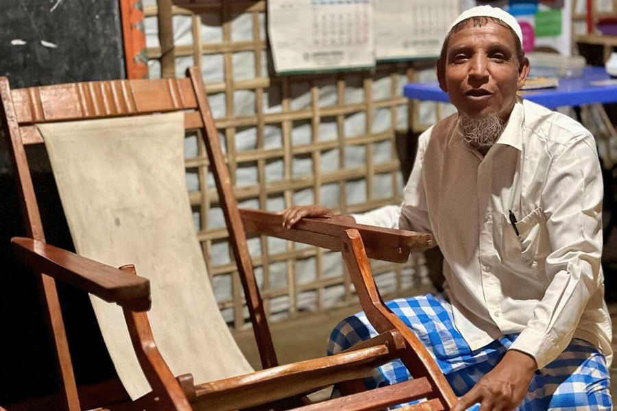 Mohammad Akter presents his wooden armchair.