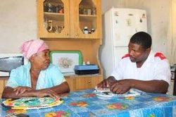 A counsellor talks with an older woman during a home visit; archive photo from newsletter no. 35.