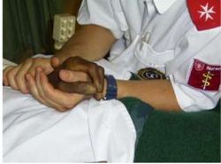 Hospice worker holding a patient’s hand