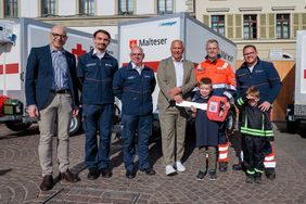 Gruppenbild mit Maltesern und politischen Amtsträgern vor dem neuen Anhänger